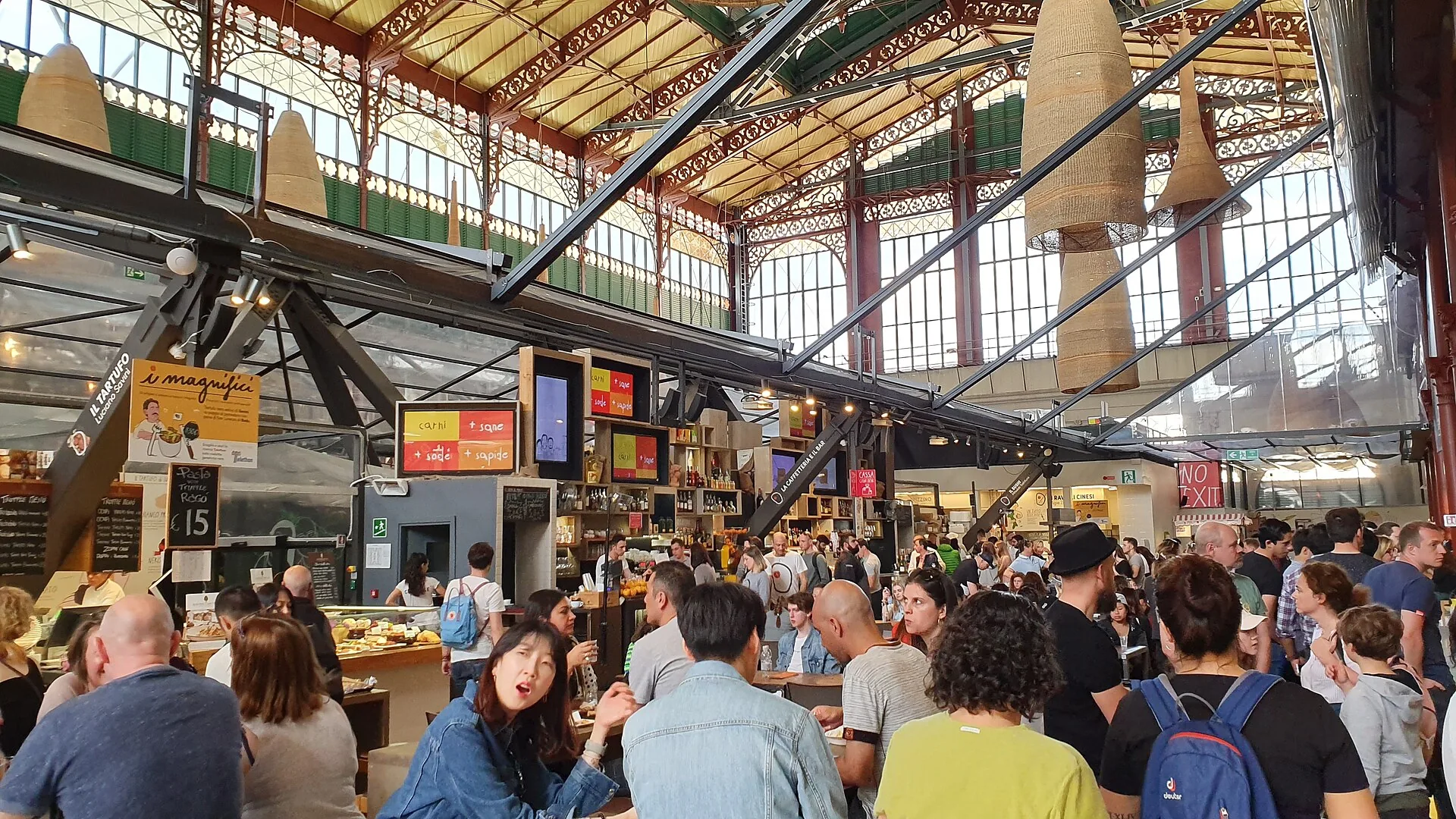The interior of Mercato Centrale in Florence, showing its upper level and decorative ironwork.