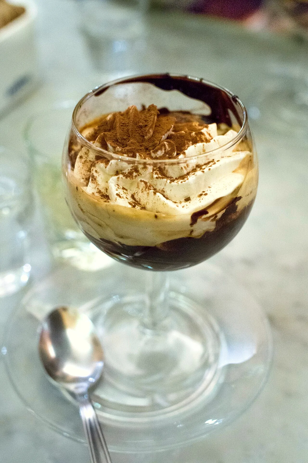 A glass of bicerin, a hot drink combining chocolate, espresso and whipped cream.