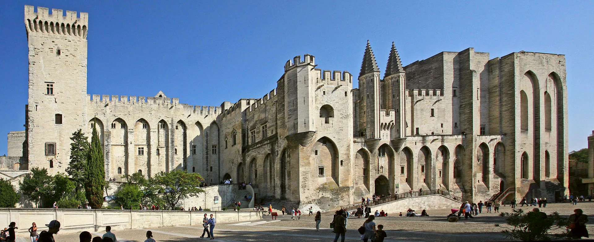 The stone façade and towers of the Palais des Papes.