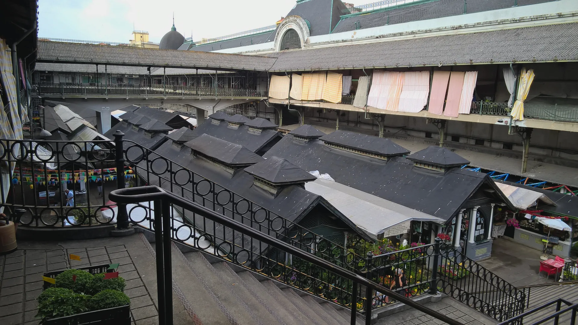 Inside Mercado do Bolhão, with its market stalls and high interior roof.