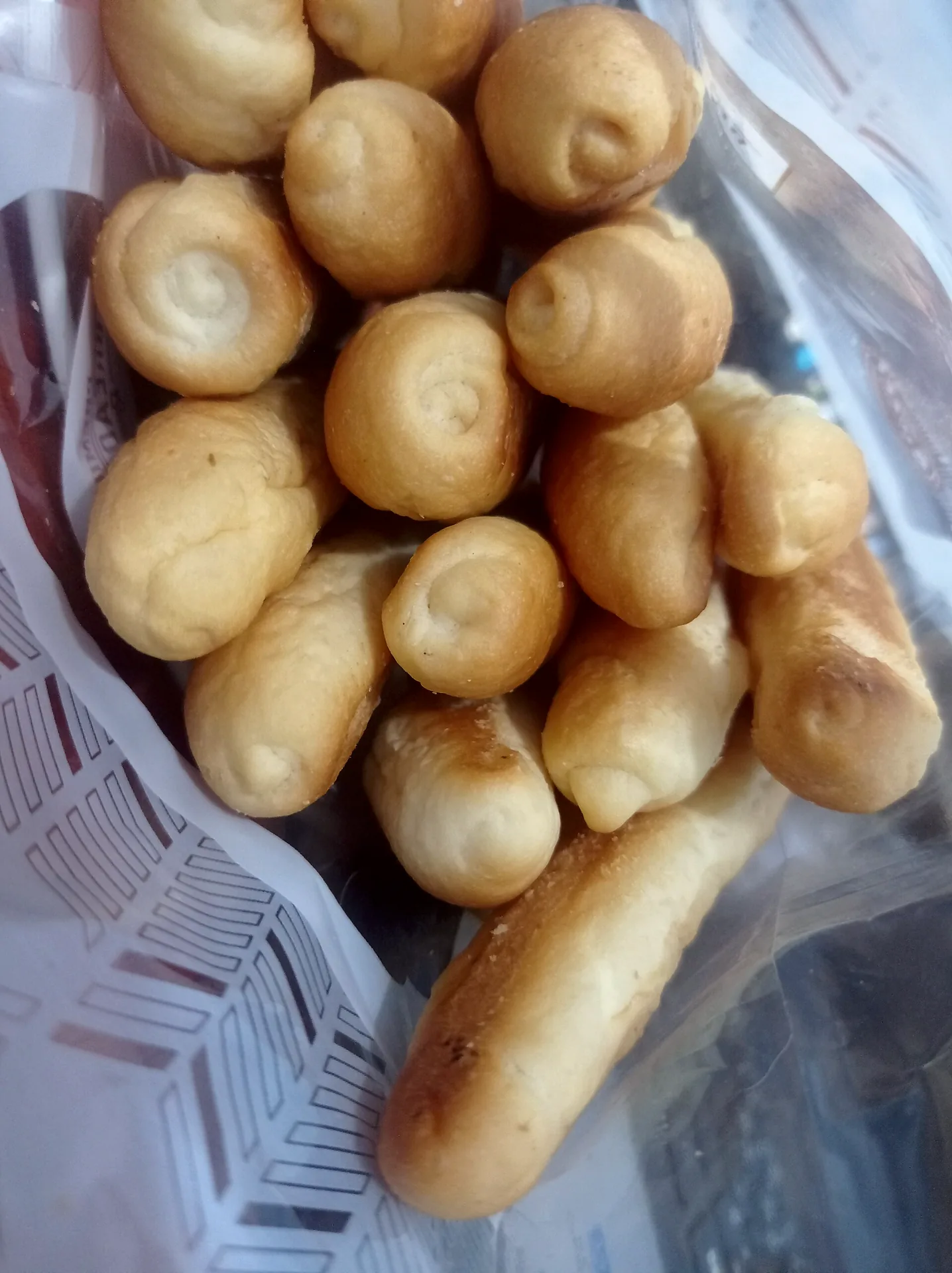 Freshly baked grissini, long, thin breadsticks arranged together.