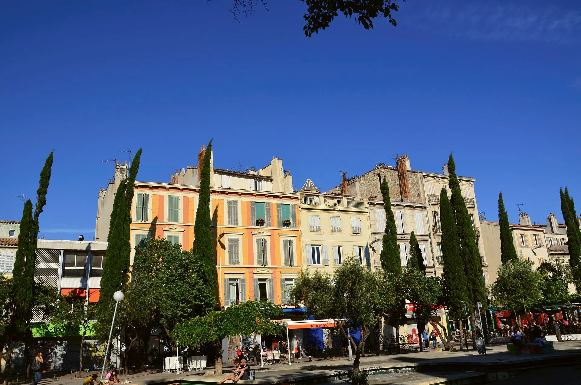 A view along Cours Julien in Marseille, with buildings and street art.