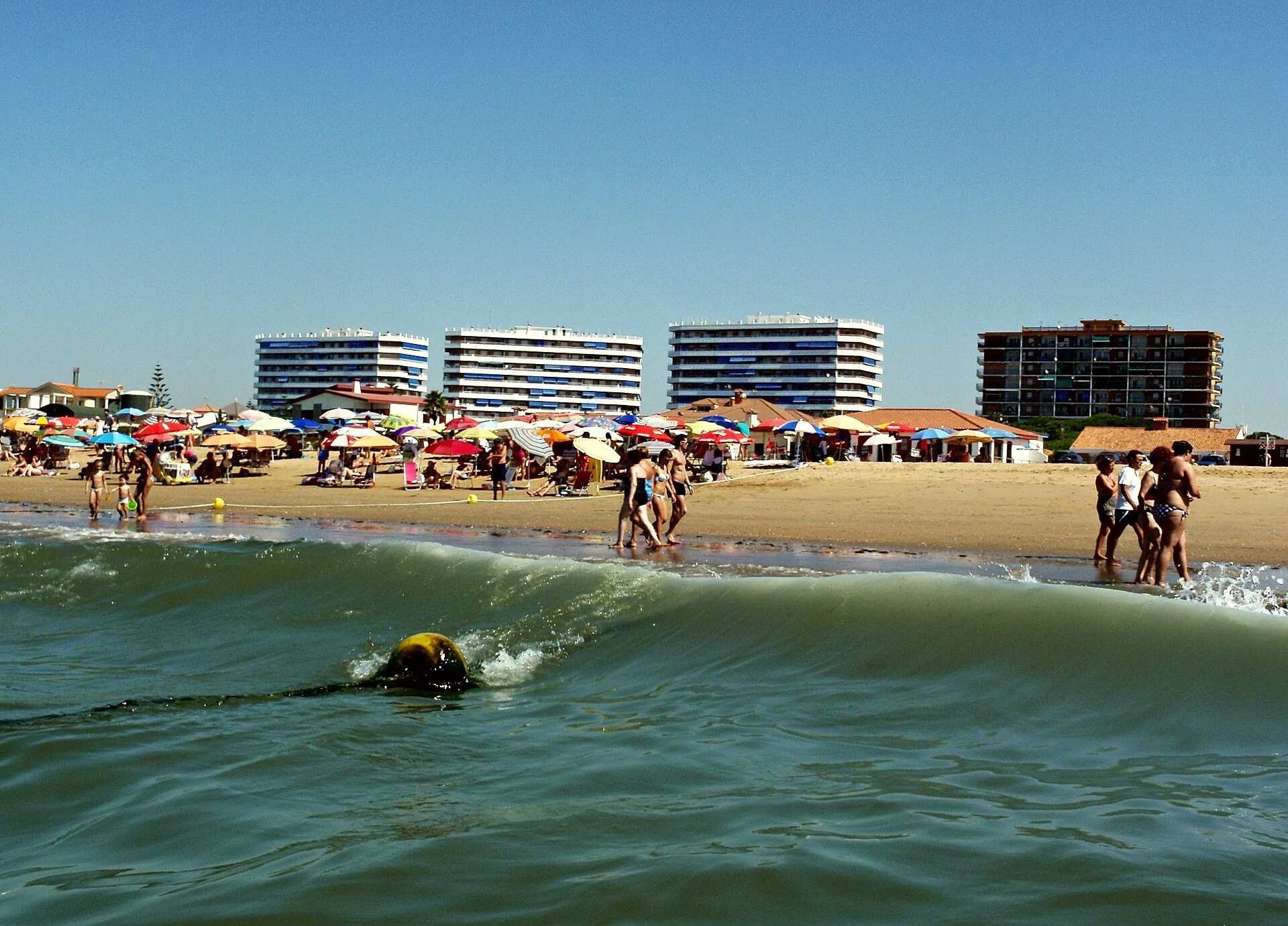 A sandy beach at Punta Umbría on a summer day.