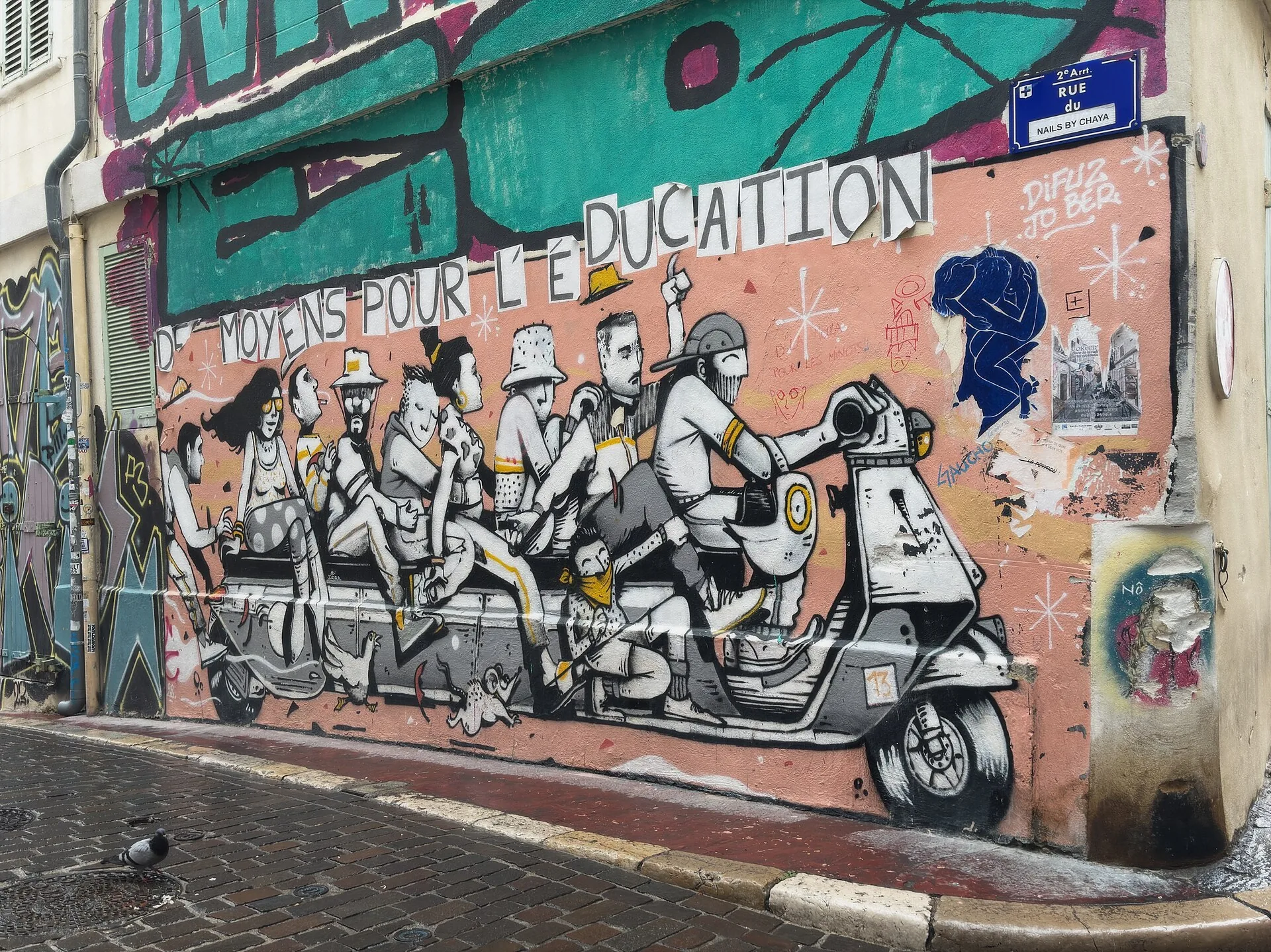 Street-art mural showing people on a bench beside a Vespa in Le Panier, Marseille