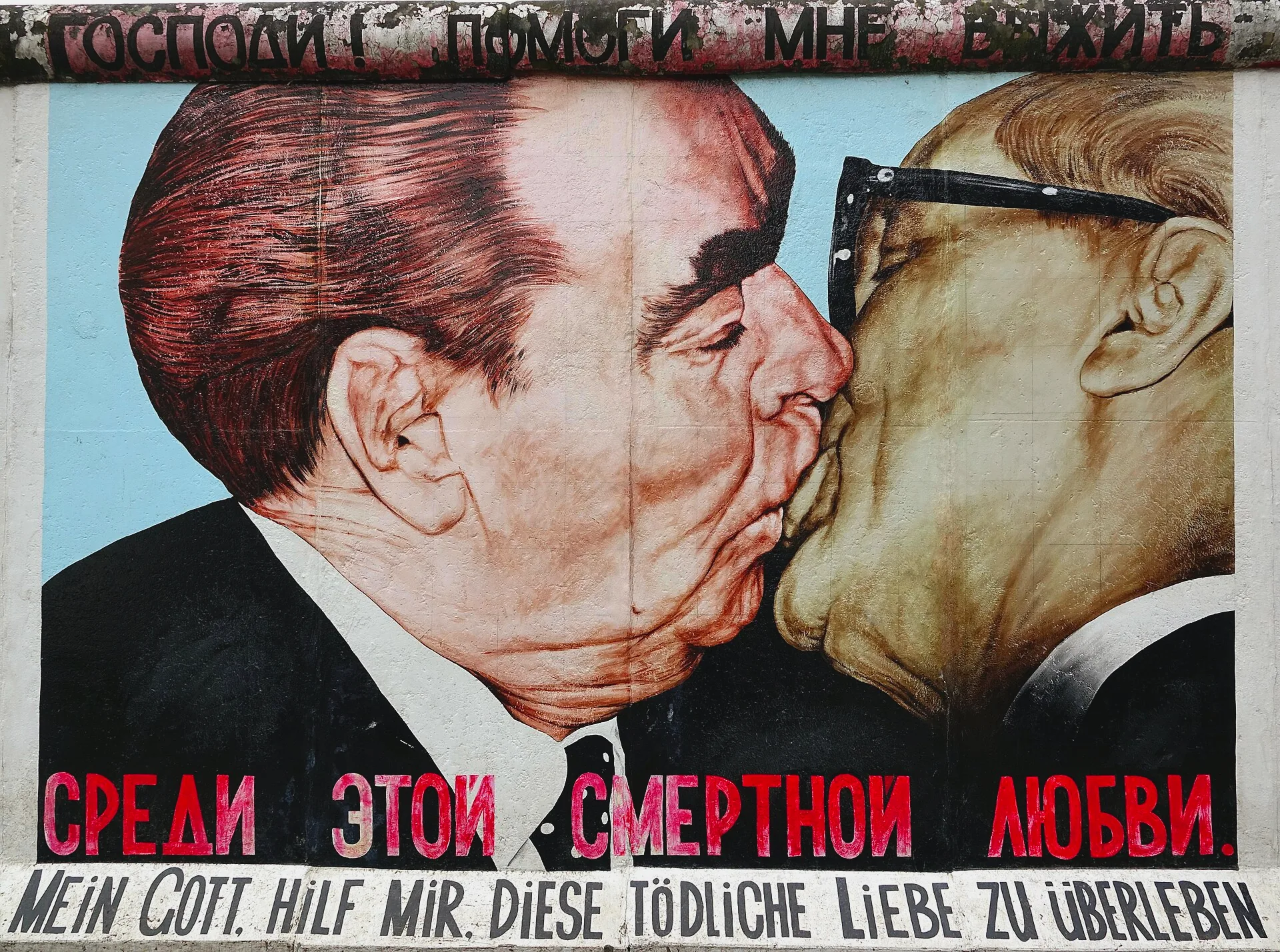 The East Side Gallery mural depicting a kiss by Dmitri Vrubel.