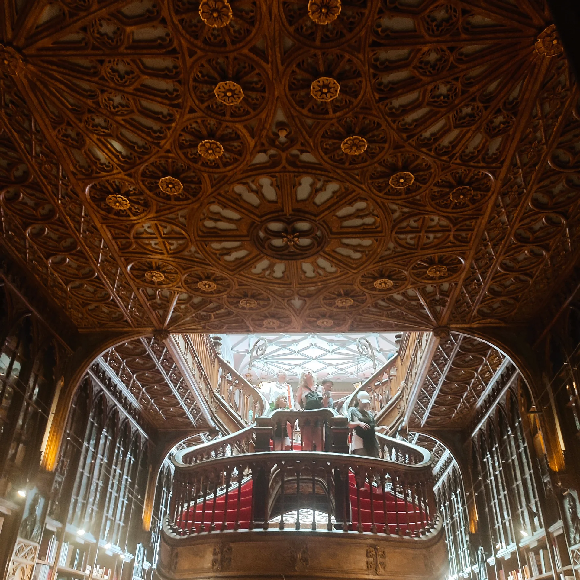 The curving wooden staircase inside Livraria Lello.