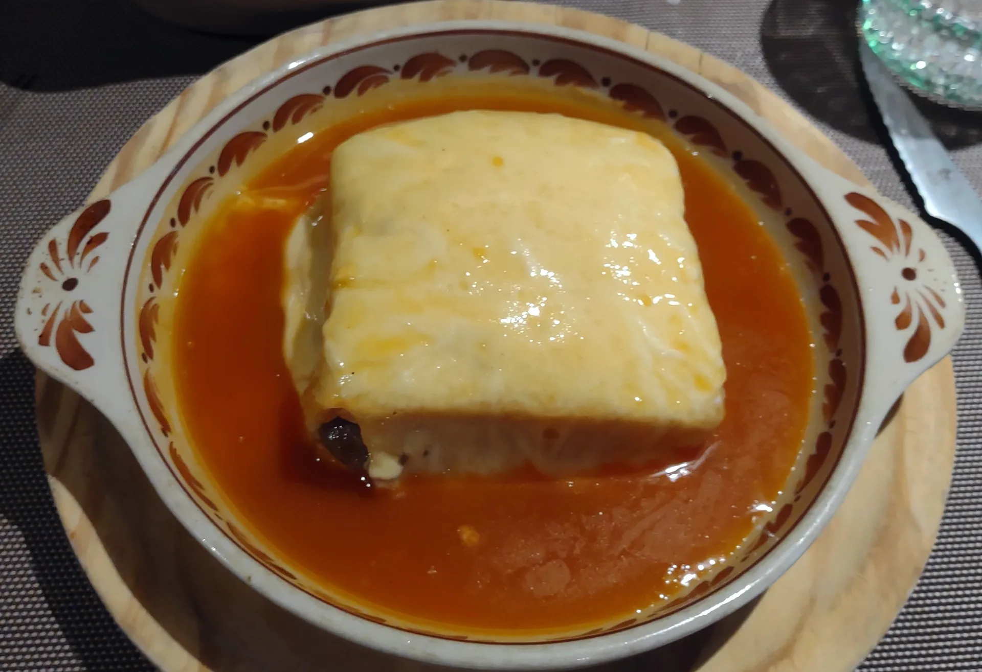 A francesinha sandwich served with sauce in Porto.