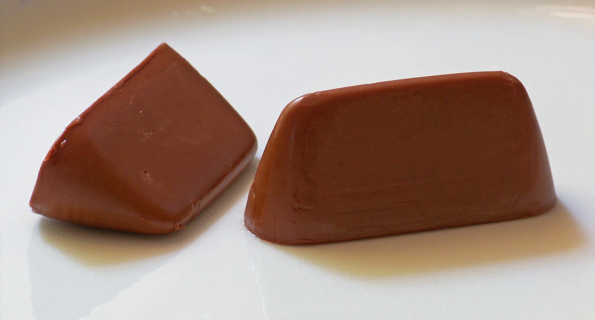 Two gianduiotti, individually wrapped in foil.