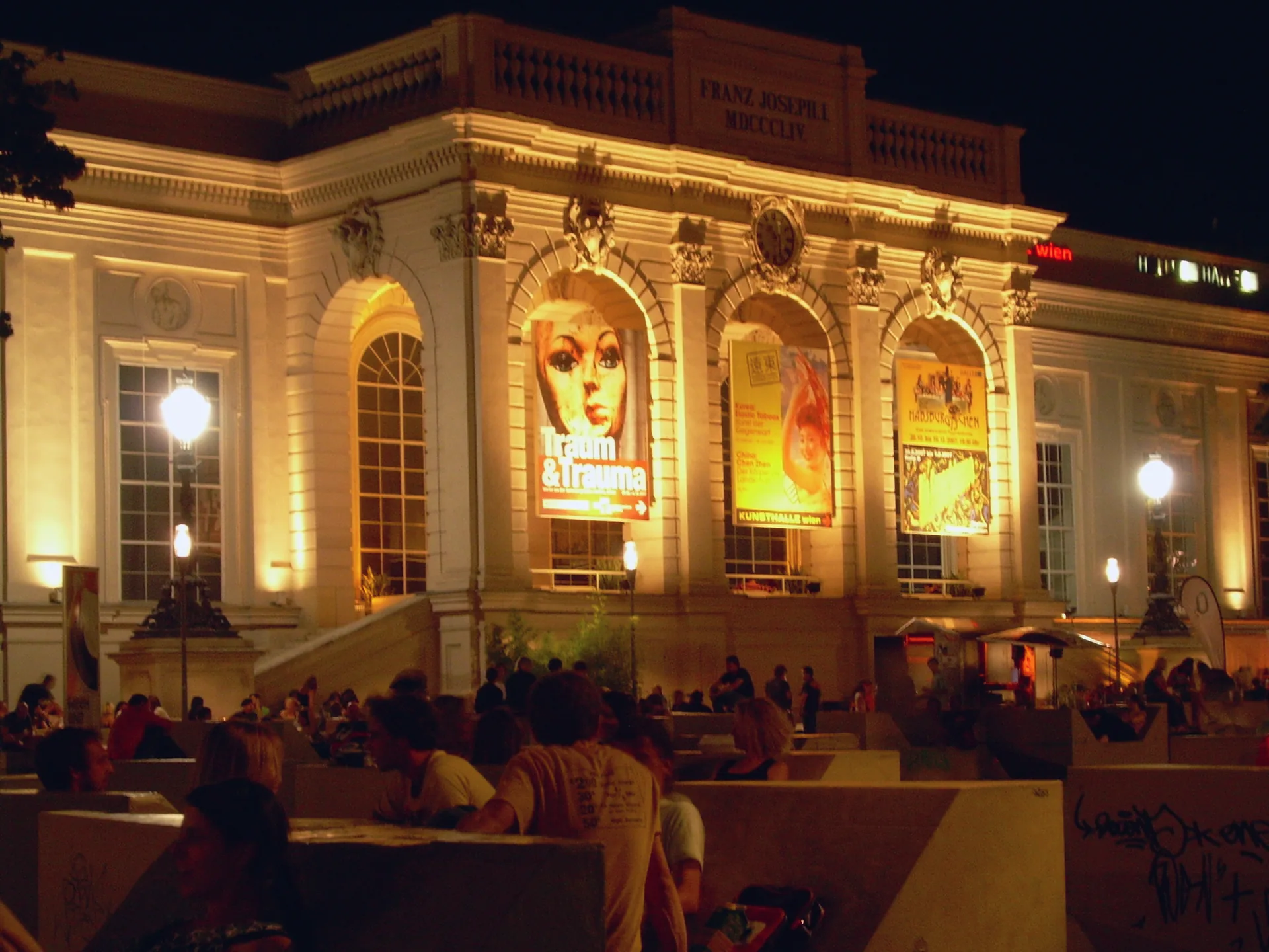 The MuseumsQuartier in Vienna at night, with the Kunsthalle building lit against the dark sky.