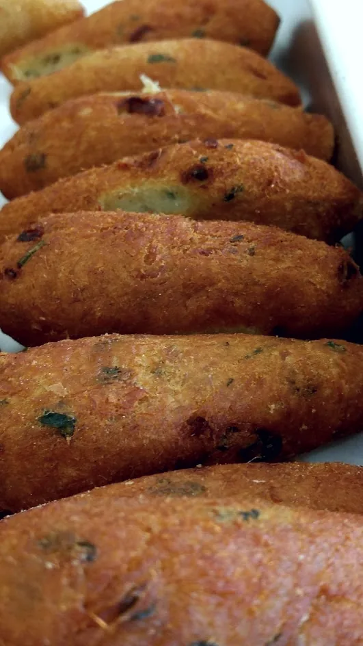 Pastéis de bacalhau, golden salt-cod fritters.
