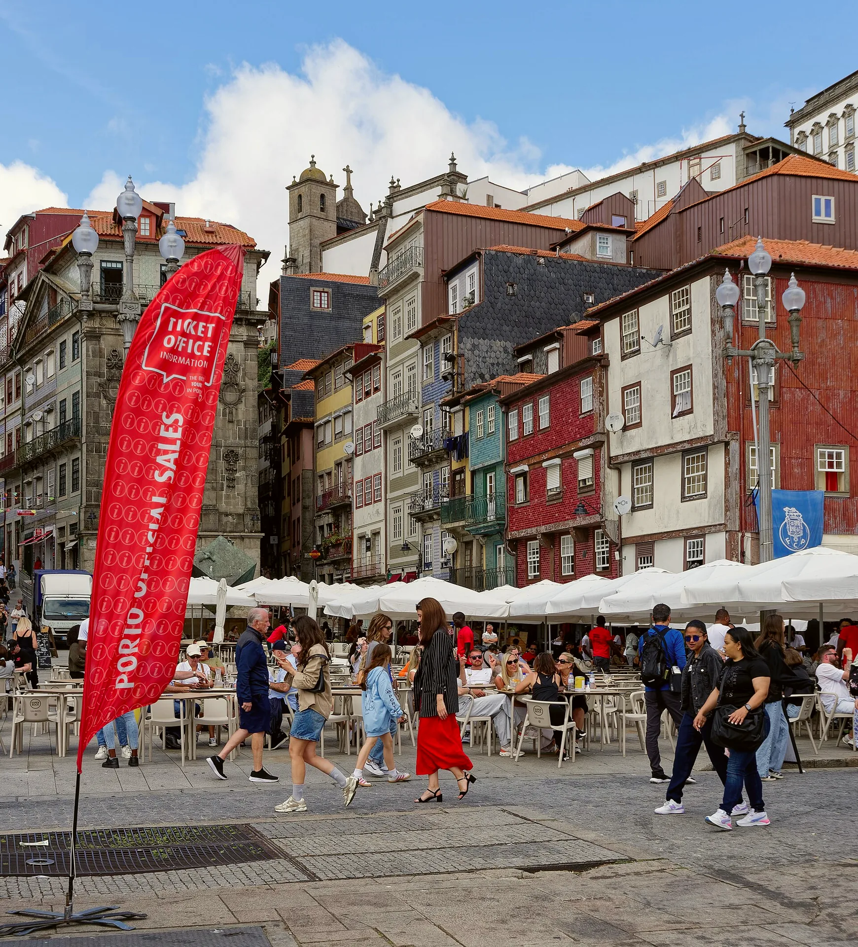 Buildings and outdoor seating around Praça da Ribeira in Porto.