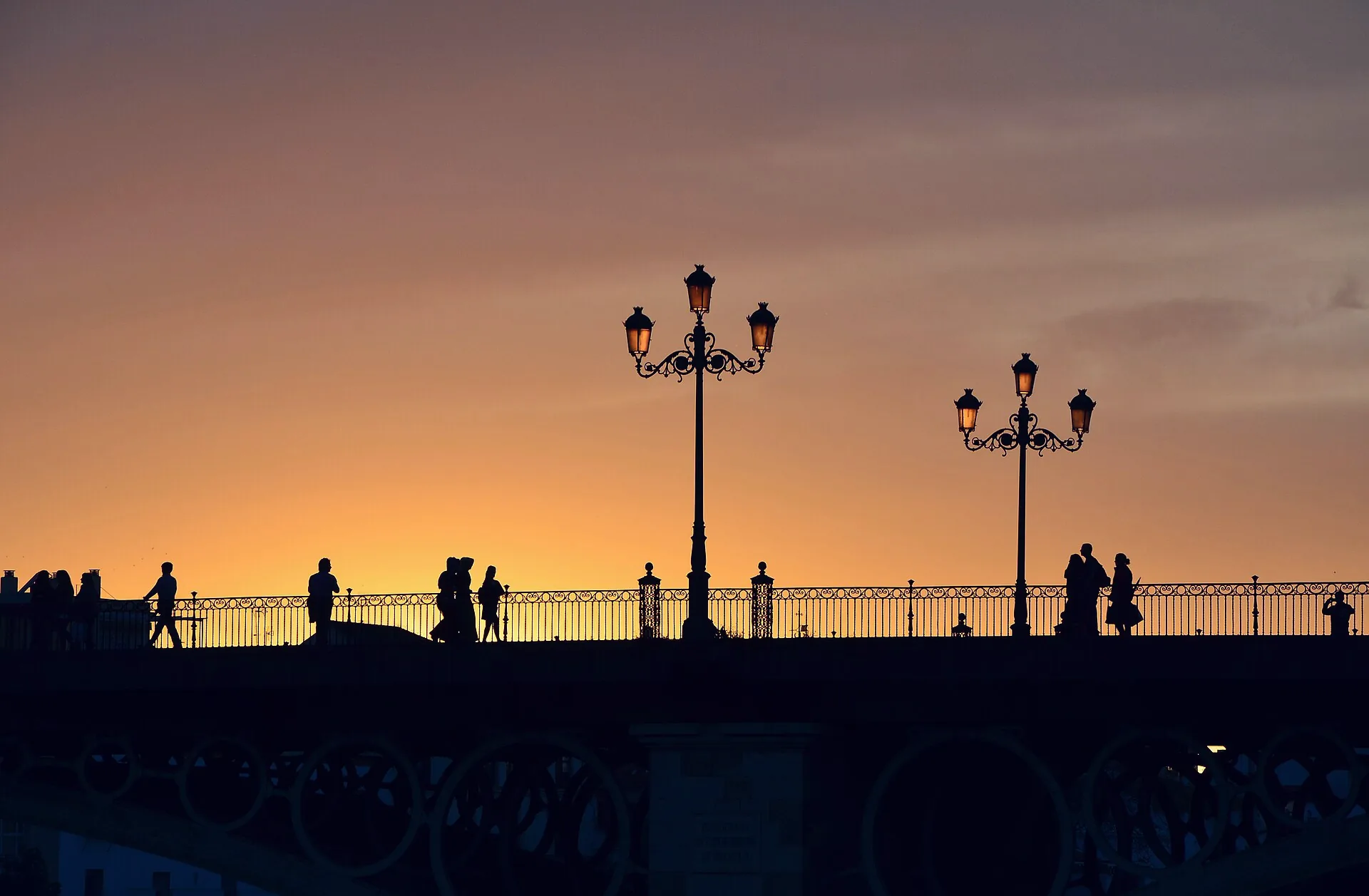 The Triana Bridge spanning the Guadalquivir at sunset.