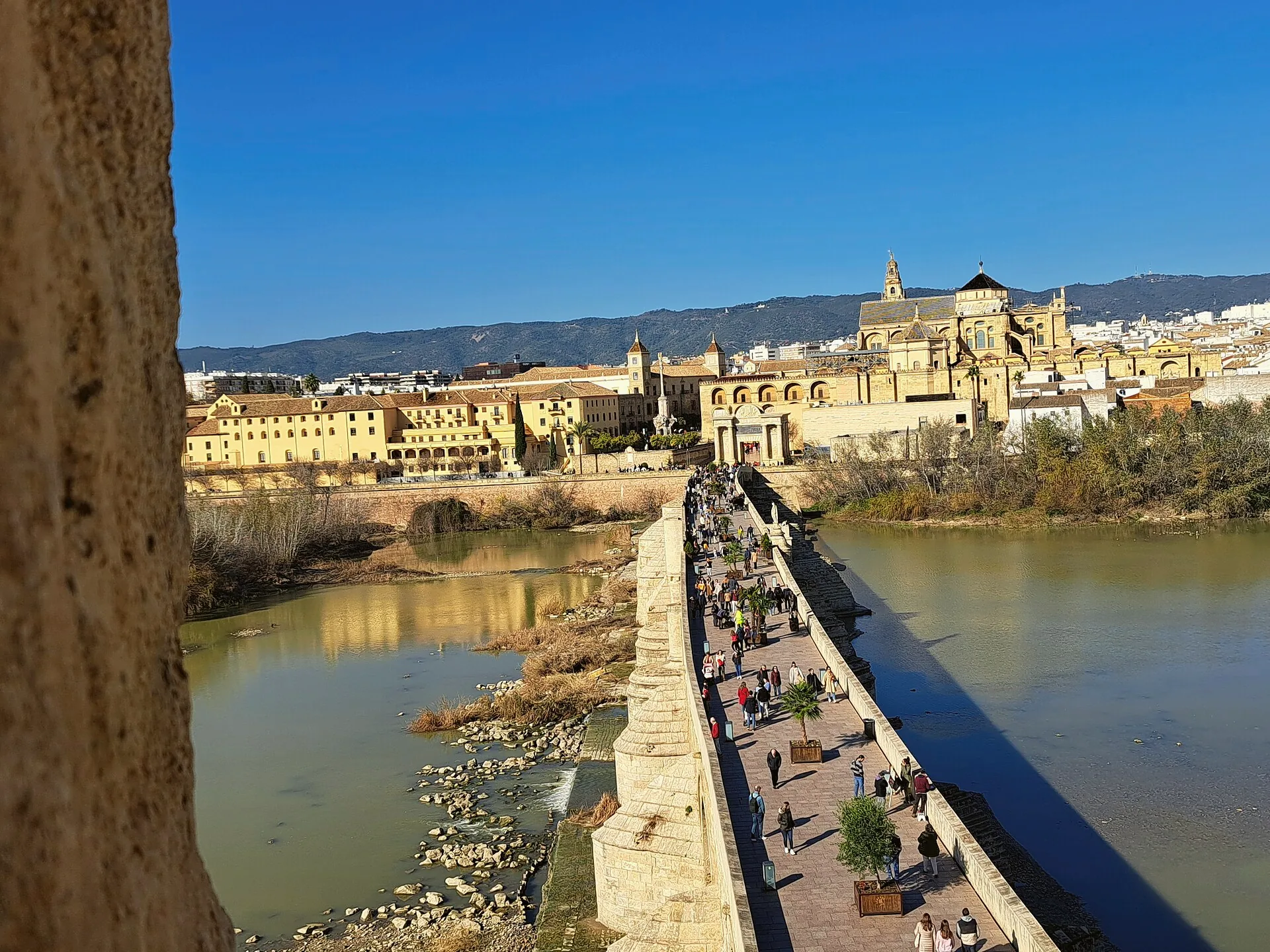 The Roman Bridge crosses the Guadalquivir, with Córdoba visible beyond.