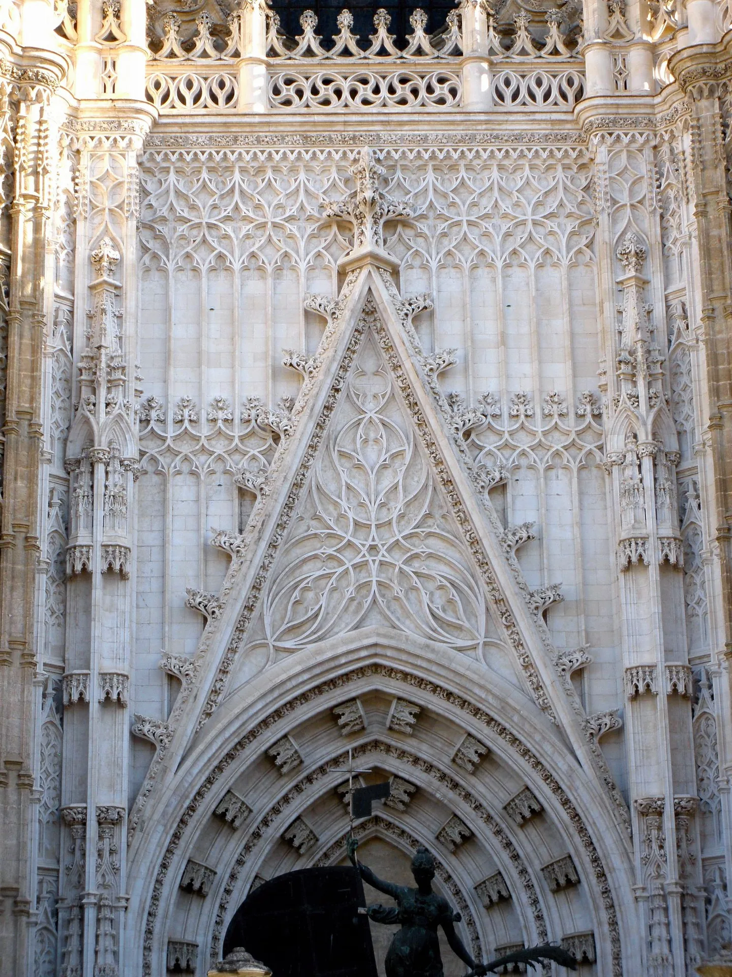 The Puerta del Príncipe, a tall stone entrance with carved detailing at Seville Cathedral.