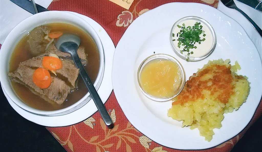 Slices of Tafelspitz with apple-horseradish, chive sauce and potato side.