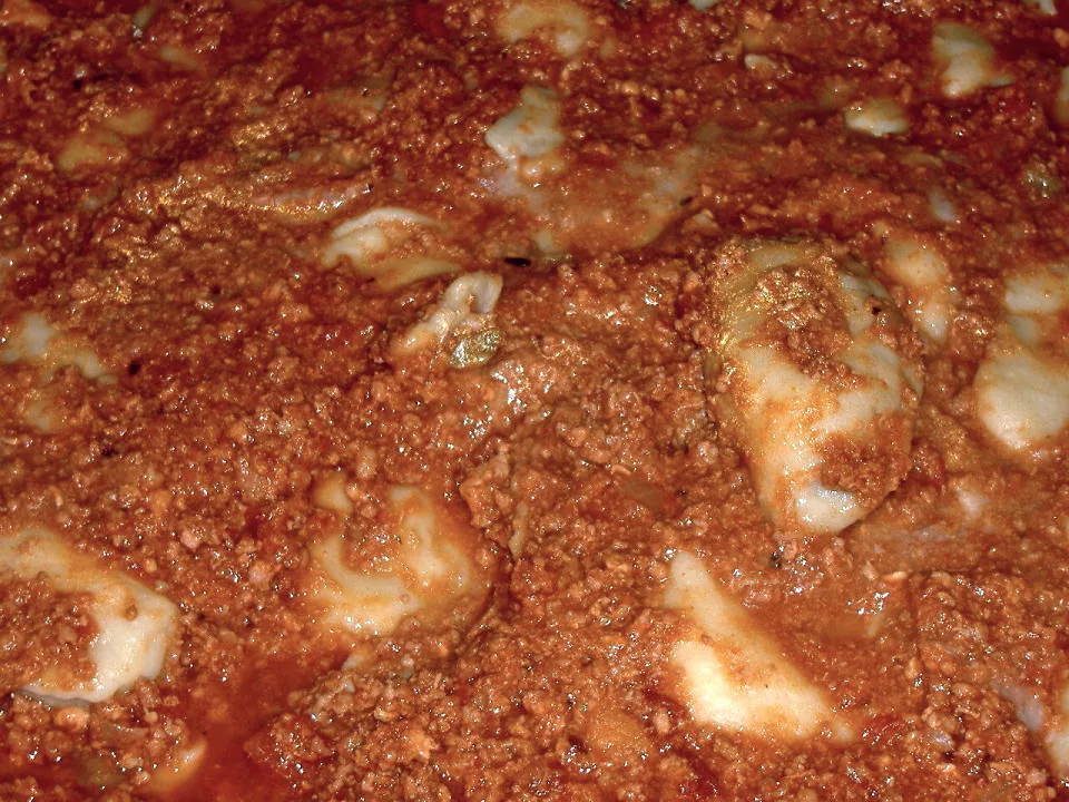 A plate of tordelli pasta served with ragù.