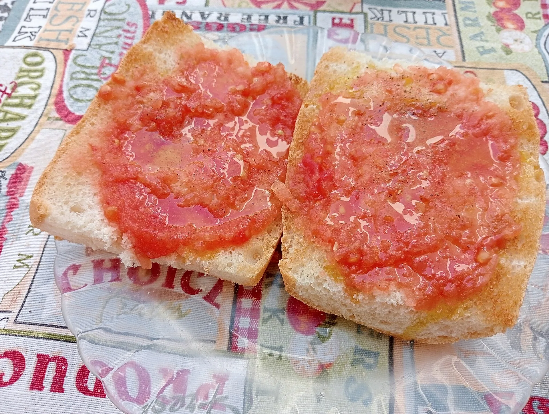 Toast topped with grated tomato on a plate.