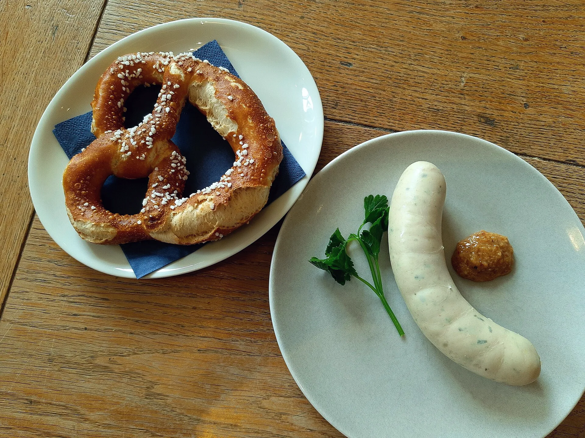 Weißwurst with mustard served on a plate