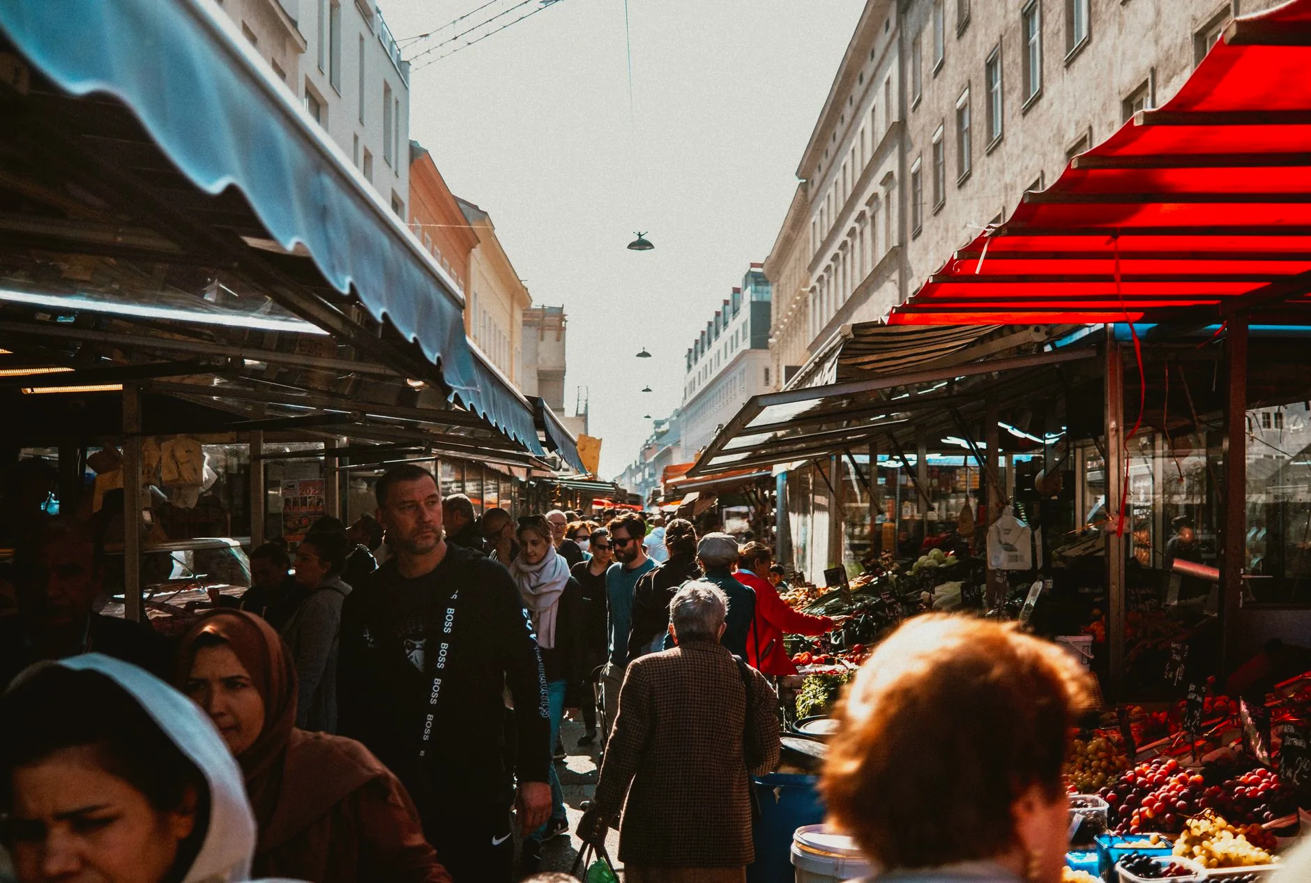 Crowds browse food stalls at Vienna’s Naschmarkt.