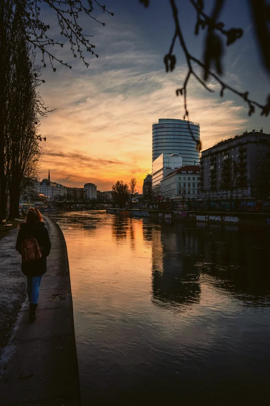 The Donaukanal at sunset, with Vienna’s buildings reflected in the water.
