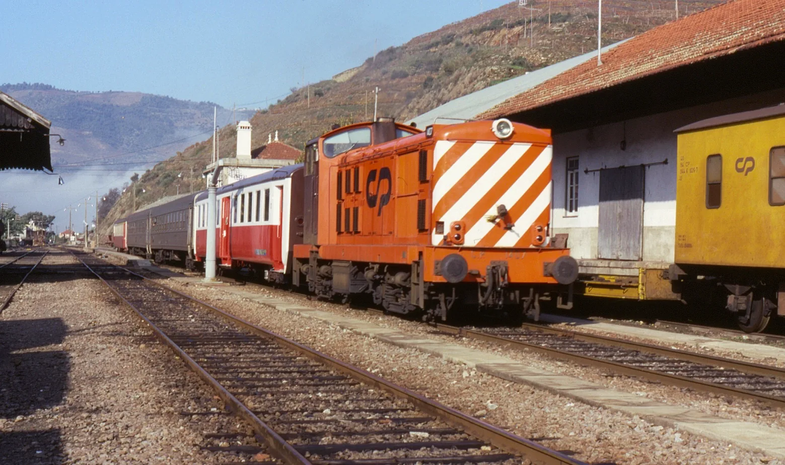 A passenger train at Tua on the railway from Porto towards Pocinho.