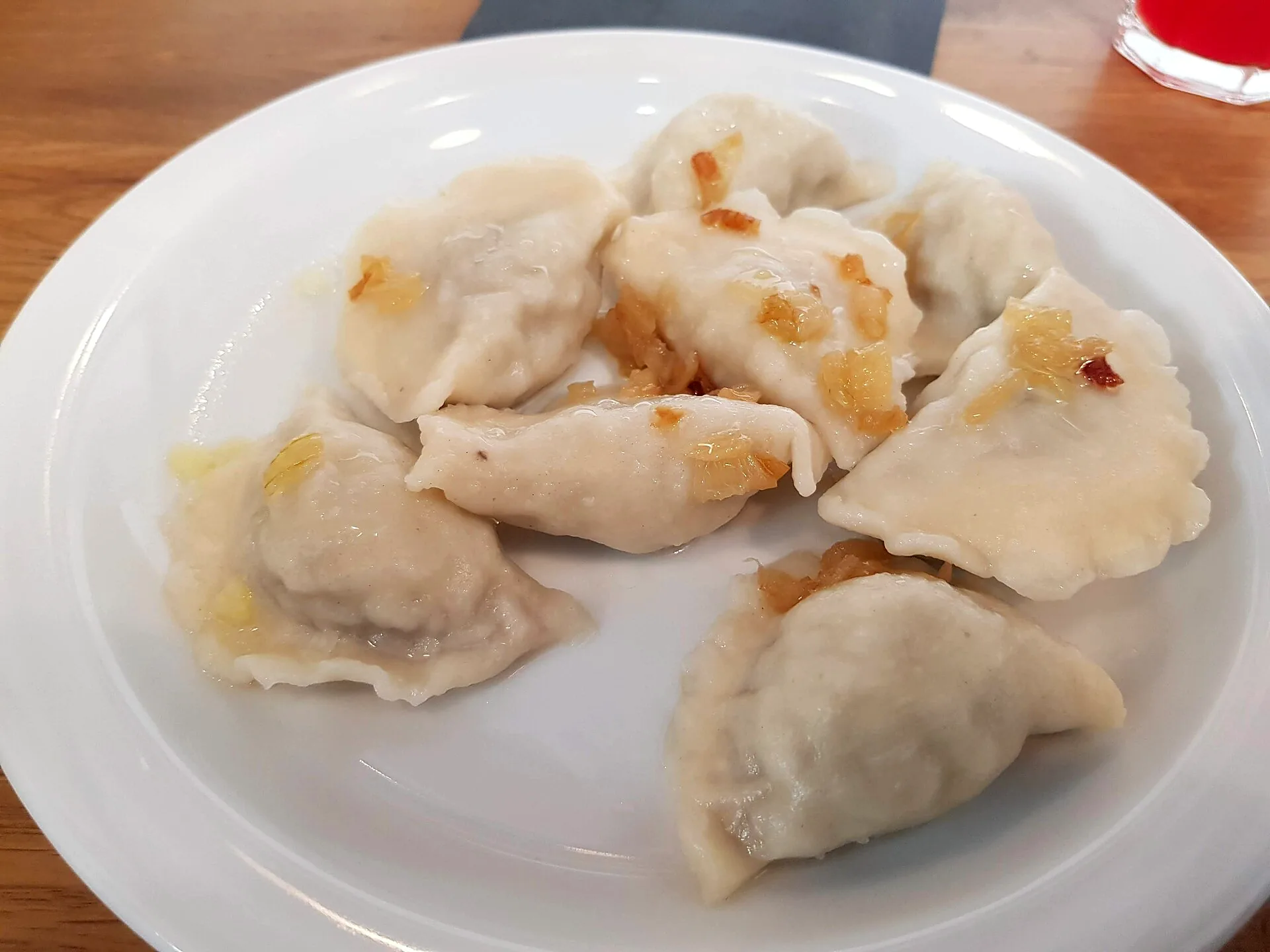 Pierogi ruskie arranged on a plate.