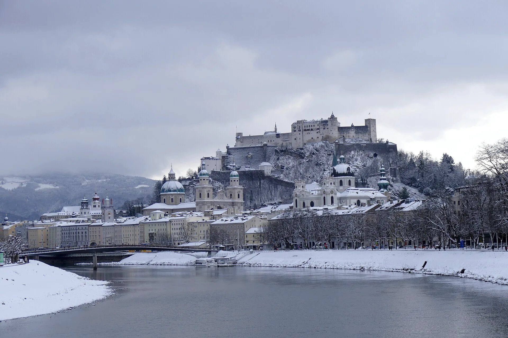 Snow-covered roofs of Salzburg’s old town viewed from Müllnersteg.