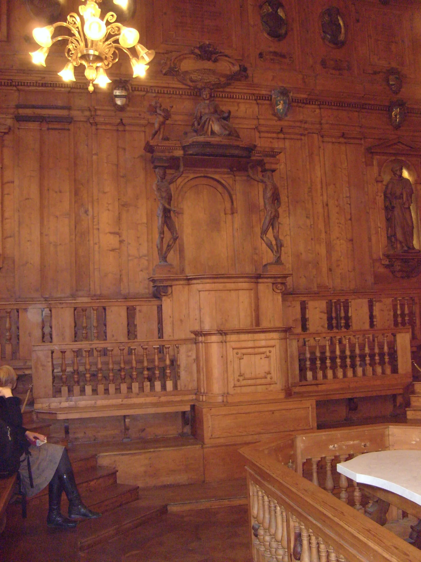 The carved wooden interior and tiered seating of Bologna’s Anatomical Theatre, with a central dissection table.