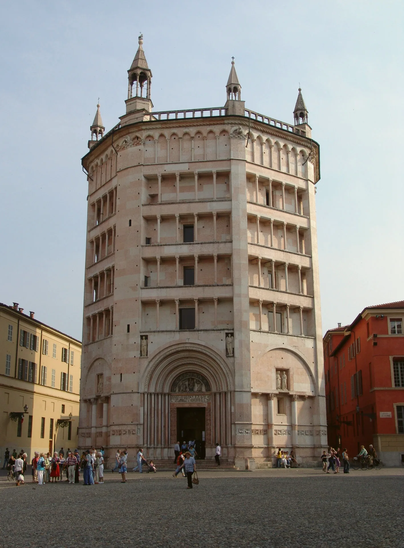 The exterior of Parma Baptistery, with its decorated entrance and patterned stonework.
