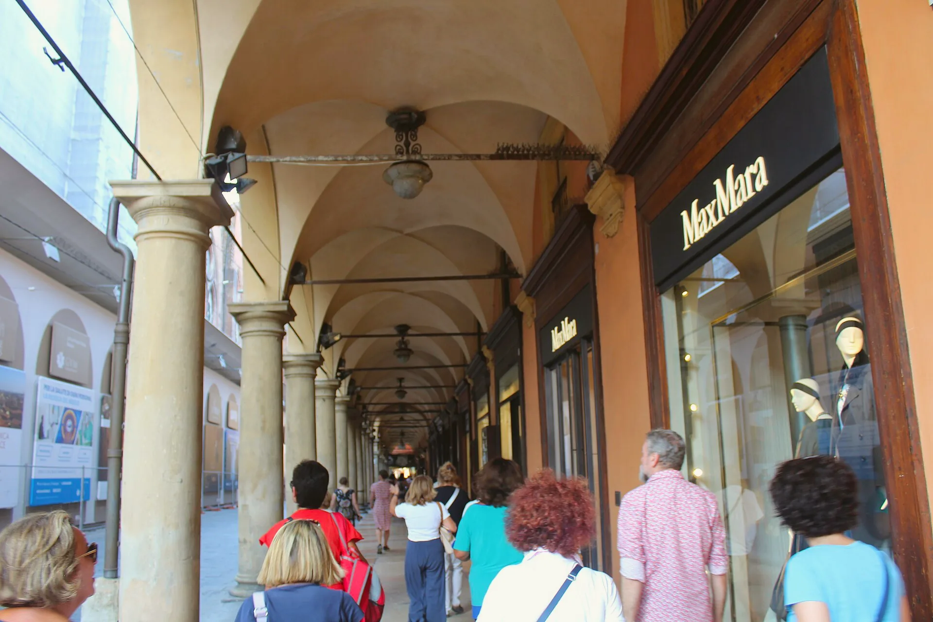 The vaulted Portico del Pavaglione in Bologna, with a long arcade of stone columns.
