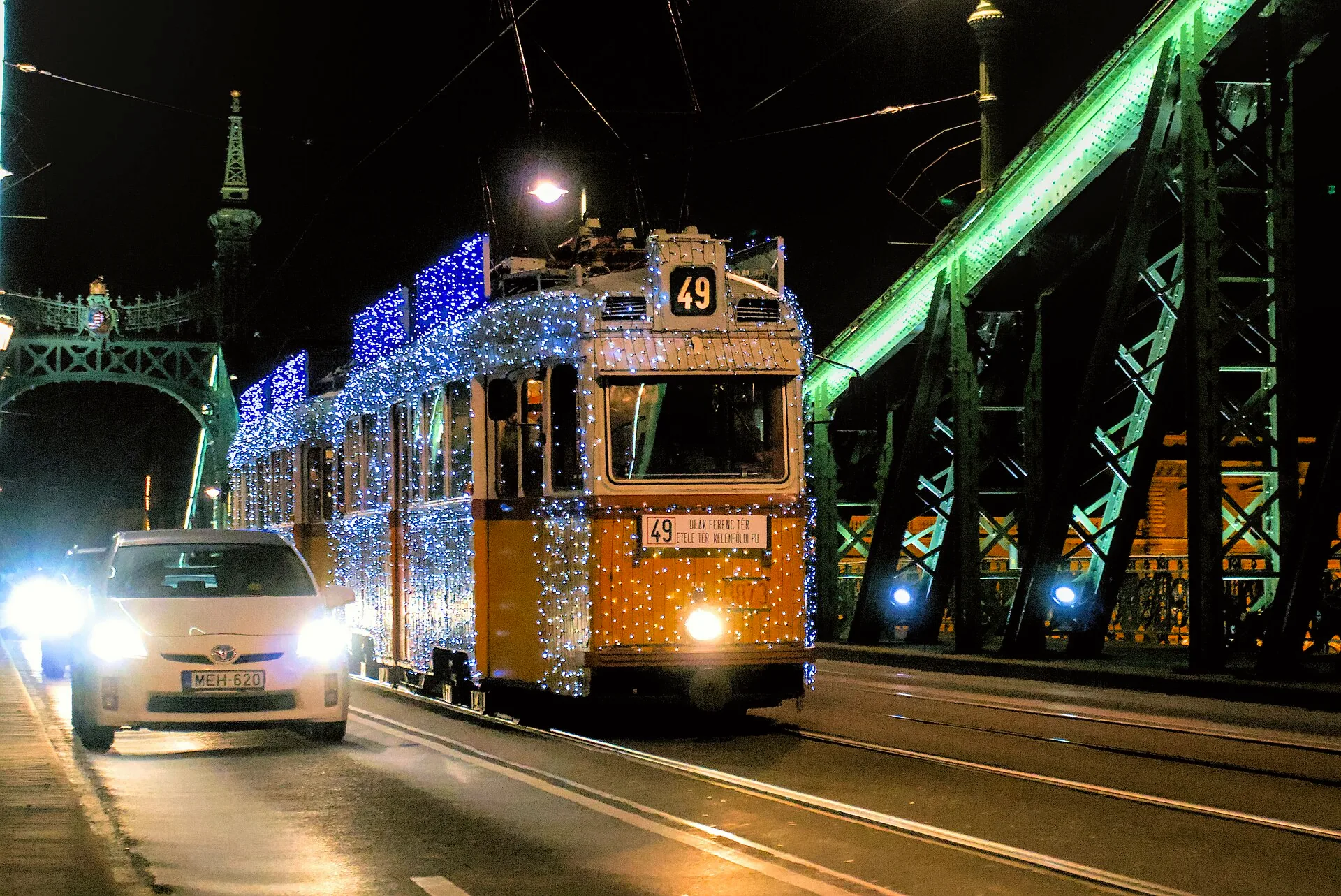 A Christmas-lit tram crosses Liberty Bridge in Budapest.