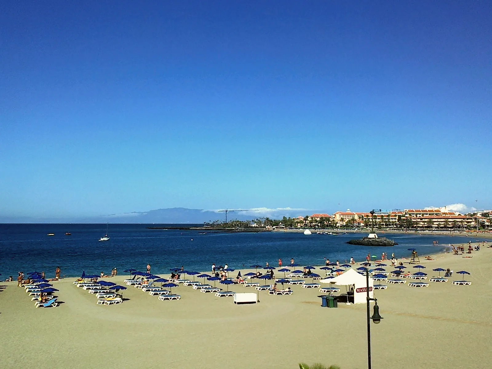The sandy shore and seawater at Playa de las Vistas in Los Cristianos.