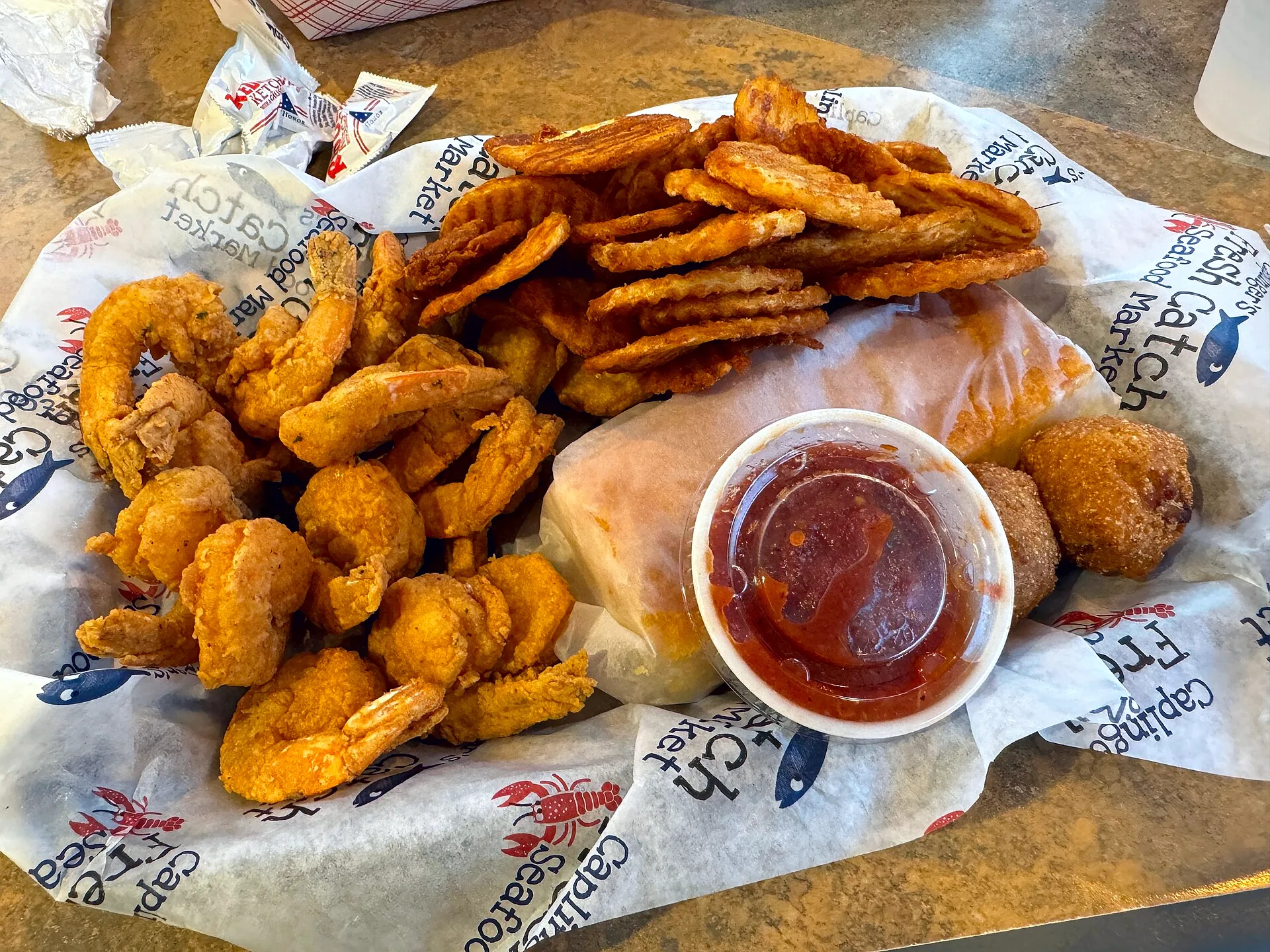 Fried shrimp served with fries, cornbread, hushpuppies and cocktail sauce.