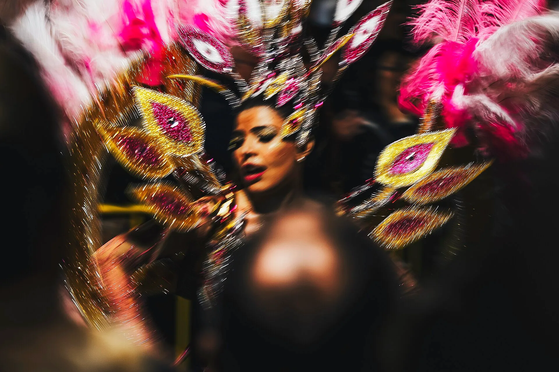 A Madeira Carnival dancer wearing a shiny peacock dress