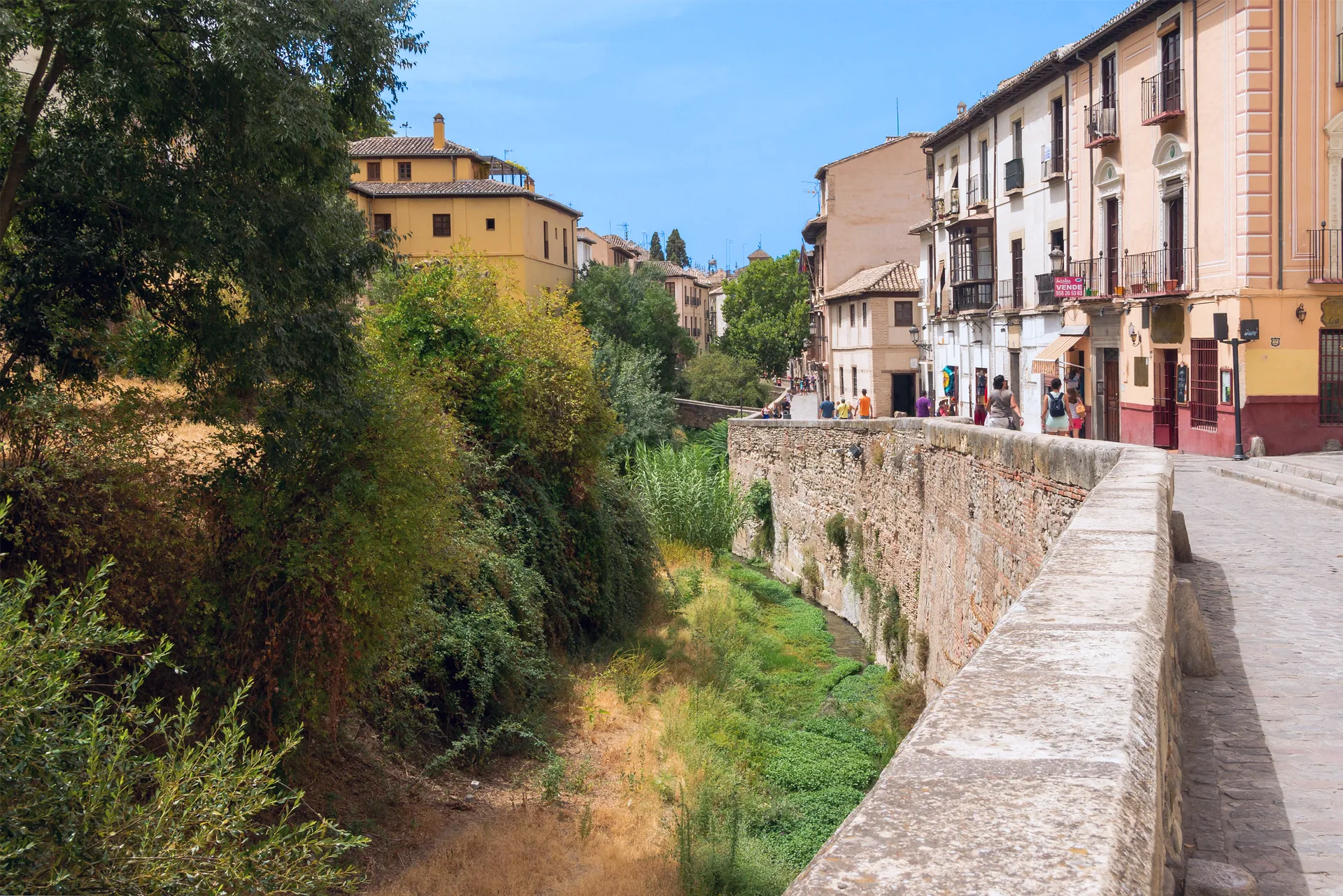 The Carrera del Darro runs beside the Darro River between the Albaicín and the Alhambra hill.
