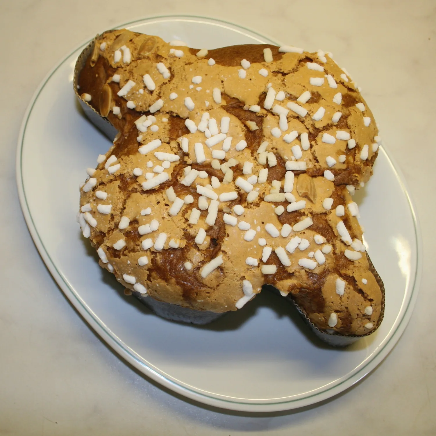 A whole colomba pasquale, an Italian Easter cake shaped like a dove and topped with almonds and pearl sugar.