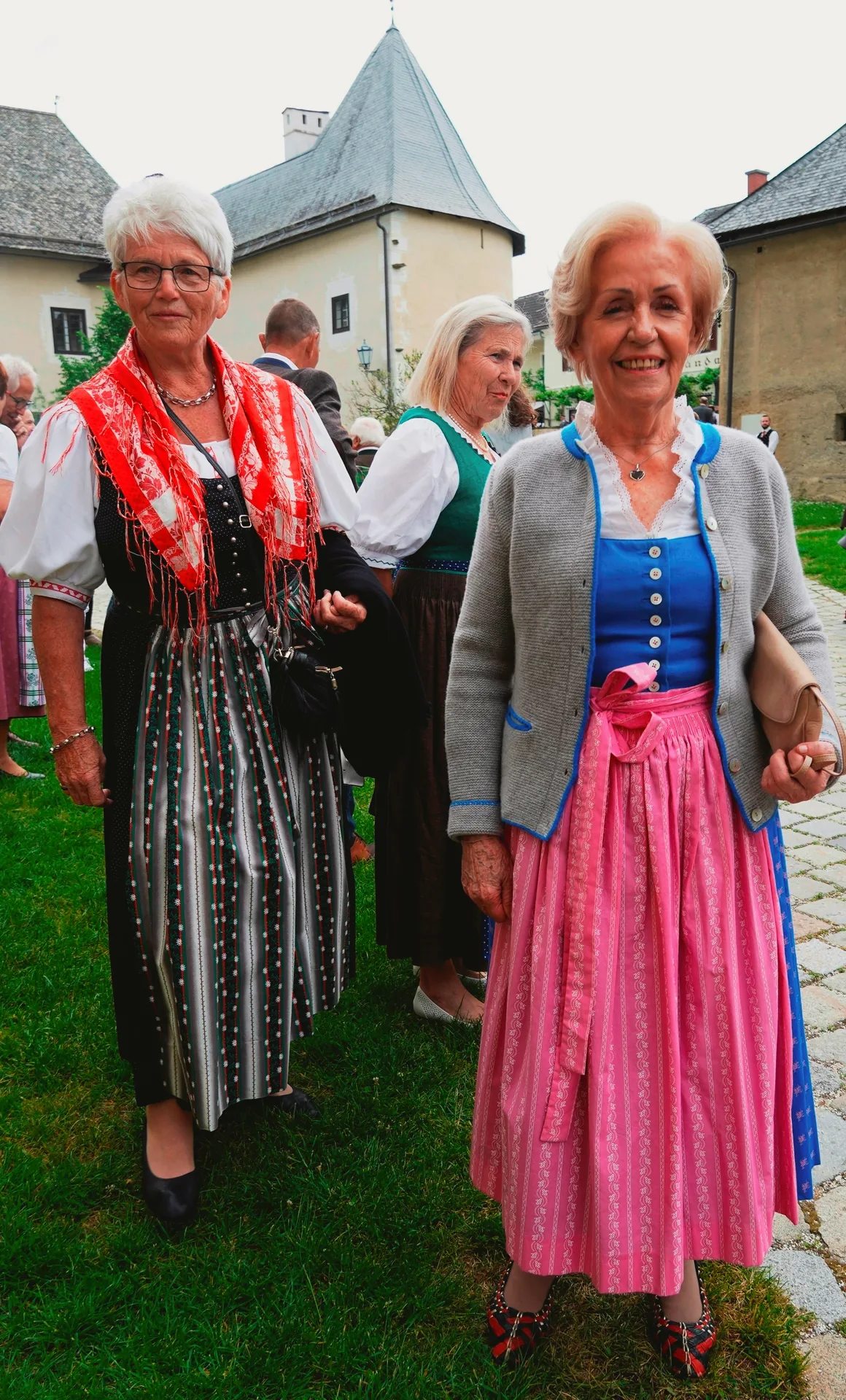 A woman wearing a summer dirndl with a fitted bodice and full skirt.