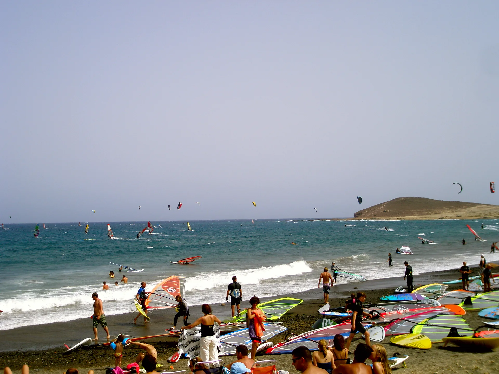 Beachgoers on the shore at El Médano, Tenerife.