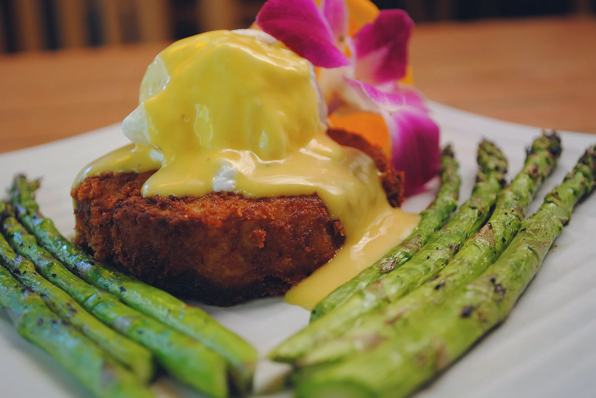A crab cake topped with a poached egg and hollandaise sauce.