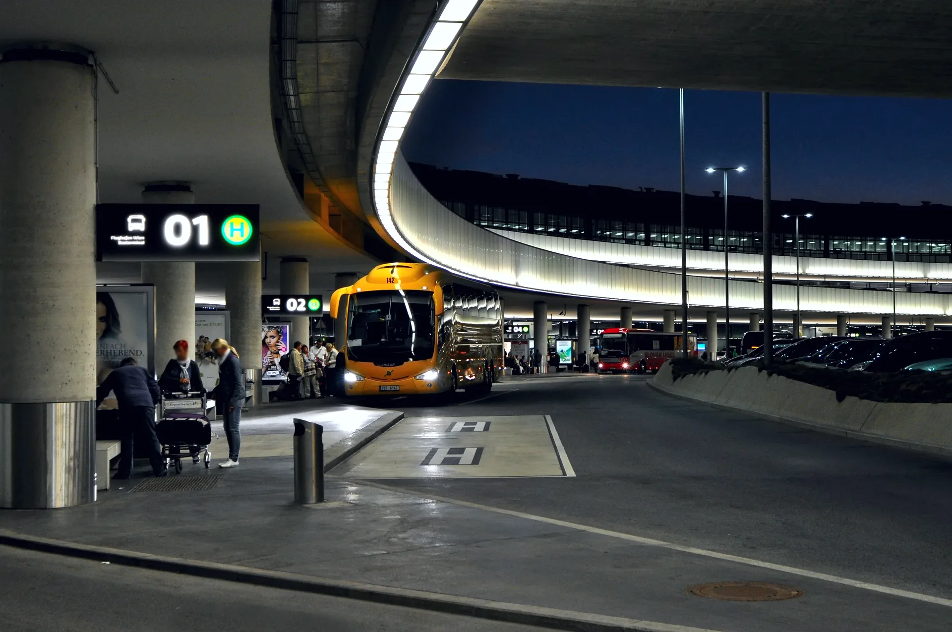 The bus terminal at Vienna Airport, with coaches parked beside the terminal building.