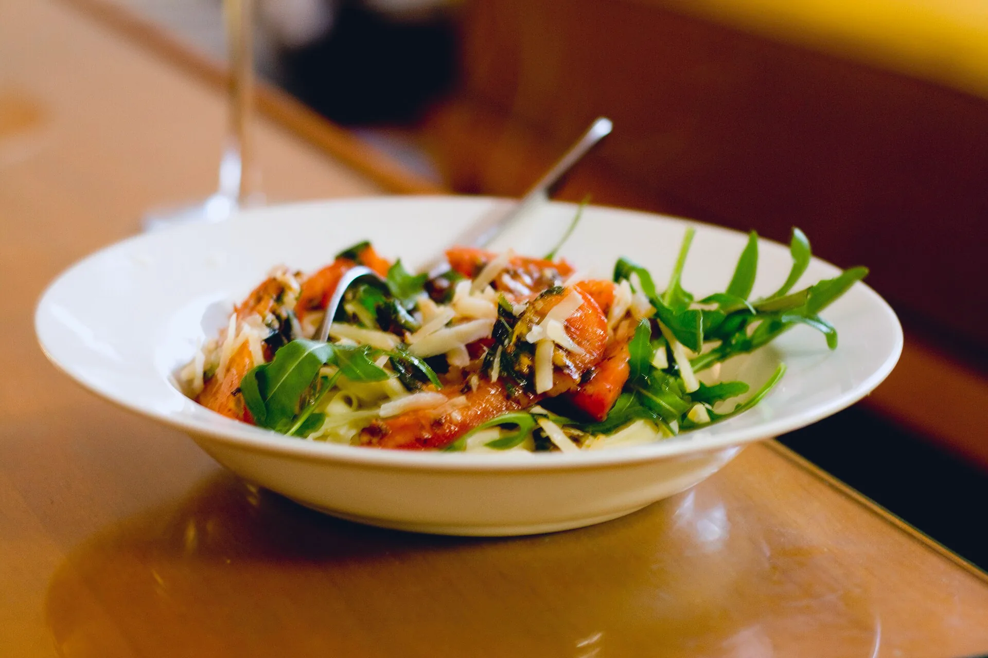 Fresh pasta served with tomatoes, parsley, rocket and grated cheese.