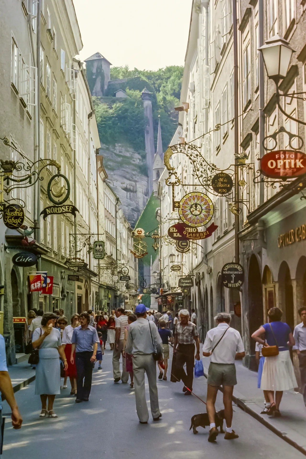The historic street of Getreidegasse in Salzburg, lined with close-set buildings.