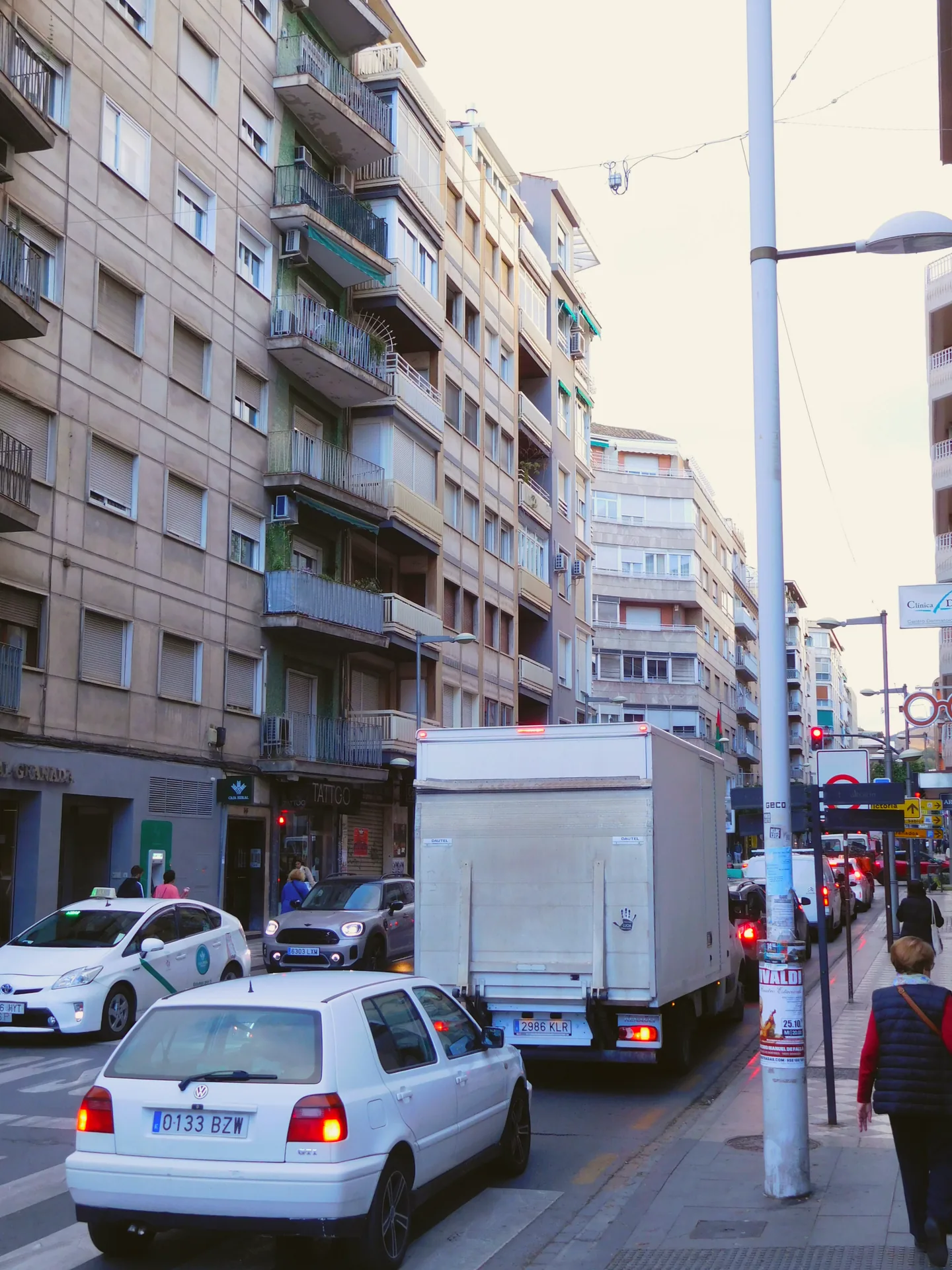 Calle Recogidas in Granada, with buildings lining the street.