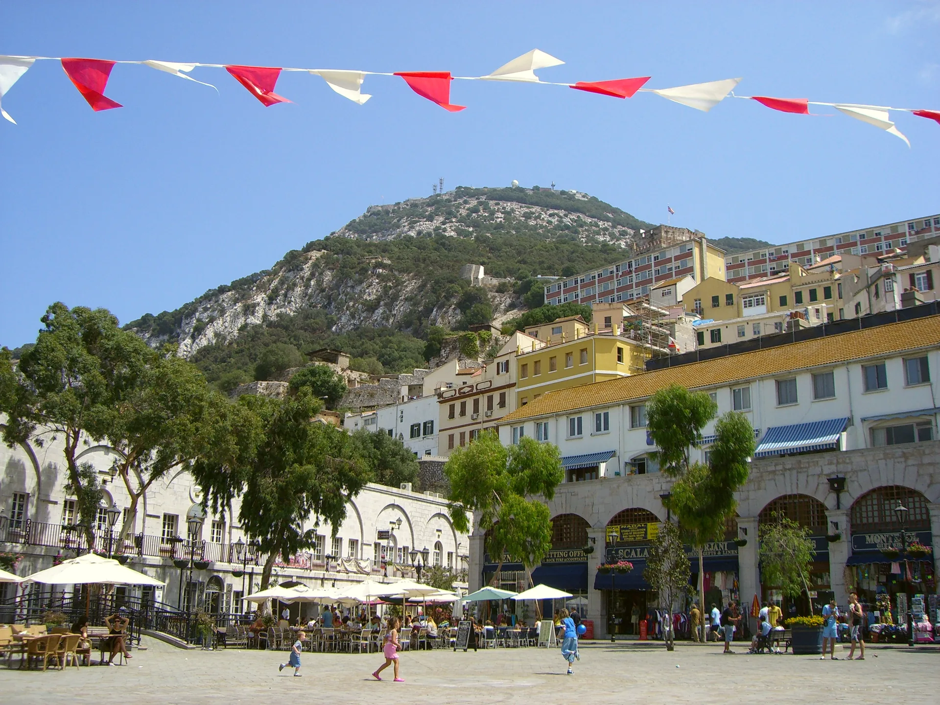 The open paved square of Grand Casemates Square, with buildings and café seating around its edges.
