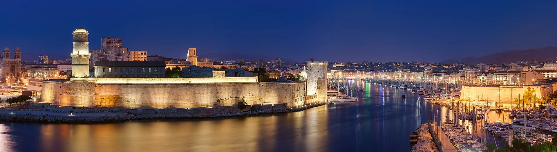 The Old Port of Marseille at night, seen from Pharo Park, with lights reflected around the harbour.