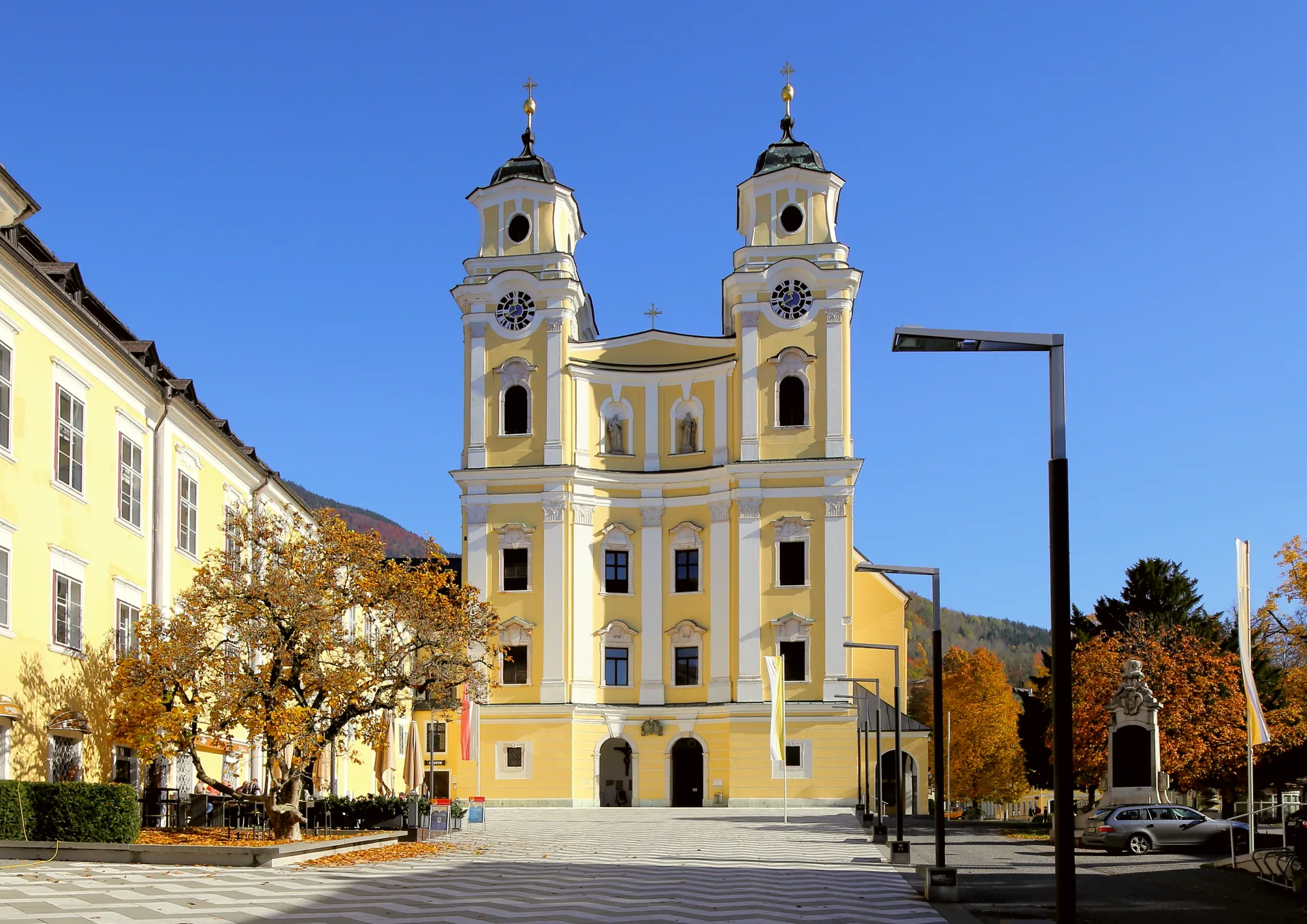West front of the Basilica of St Michael in Mondsee, with its twin towers and central entrance.