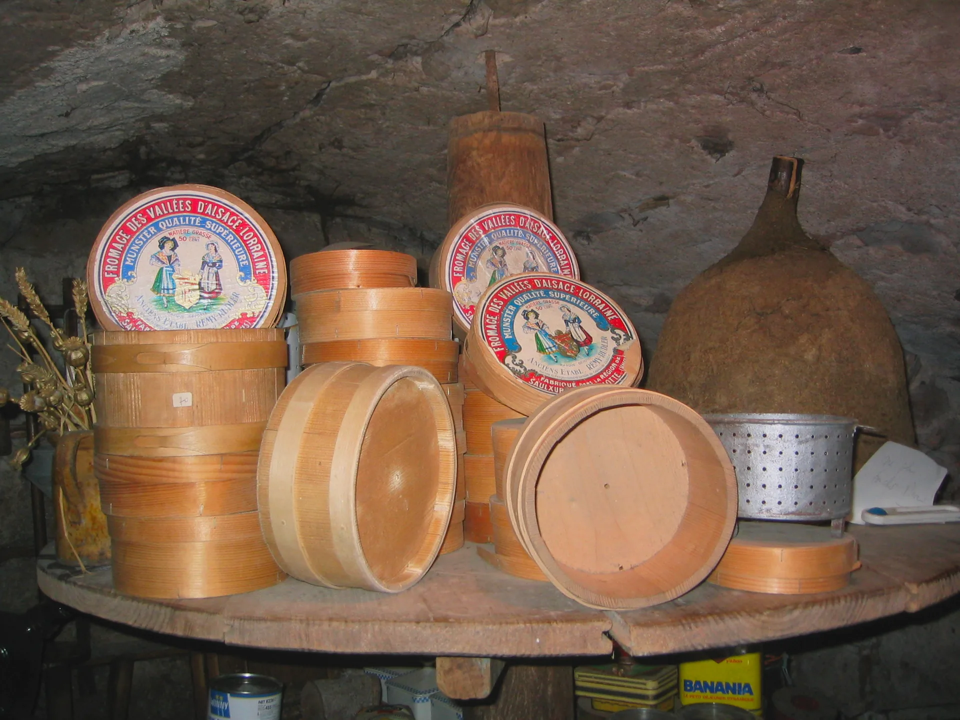 A wheel of Munster cheese displayed in a farm museum.
