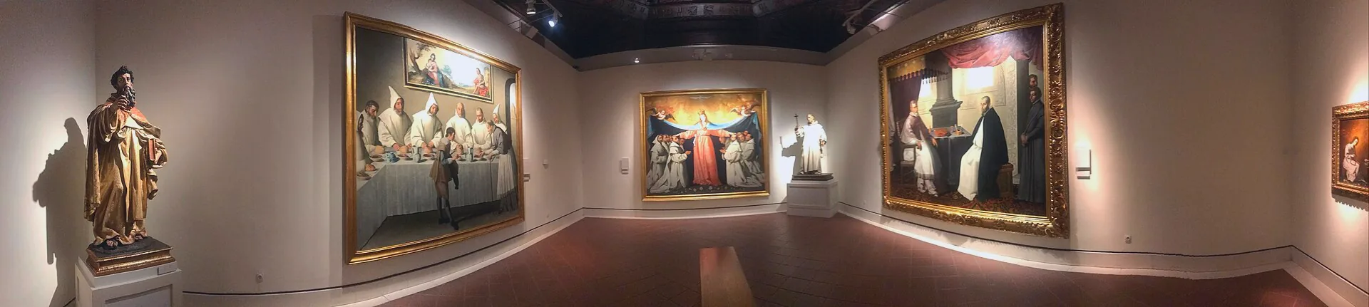 Panoramic view across a gallery in the Museo de Bellas Artes de Sevilla, with paintings displayed on the walls.