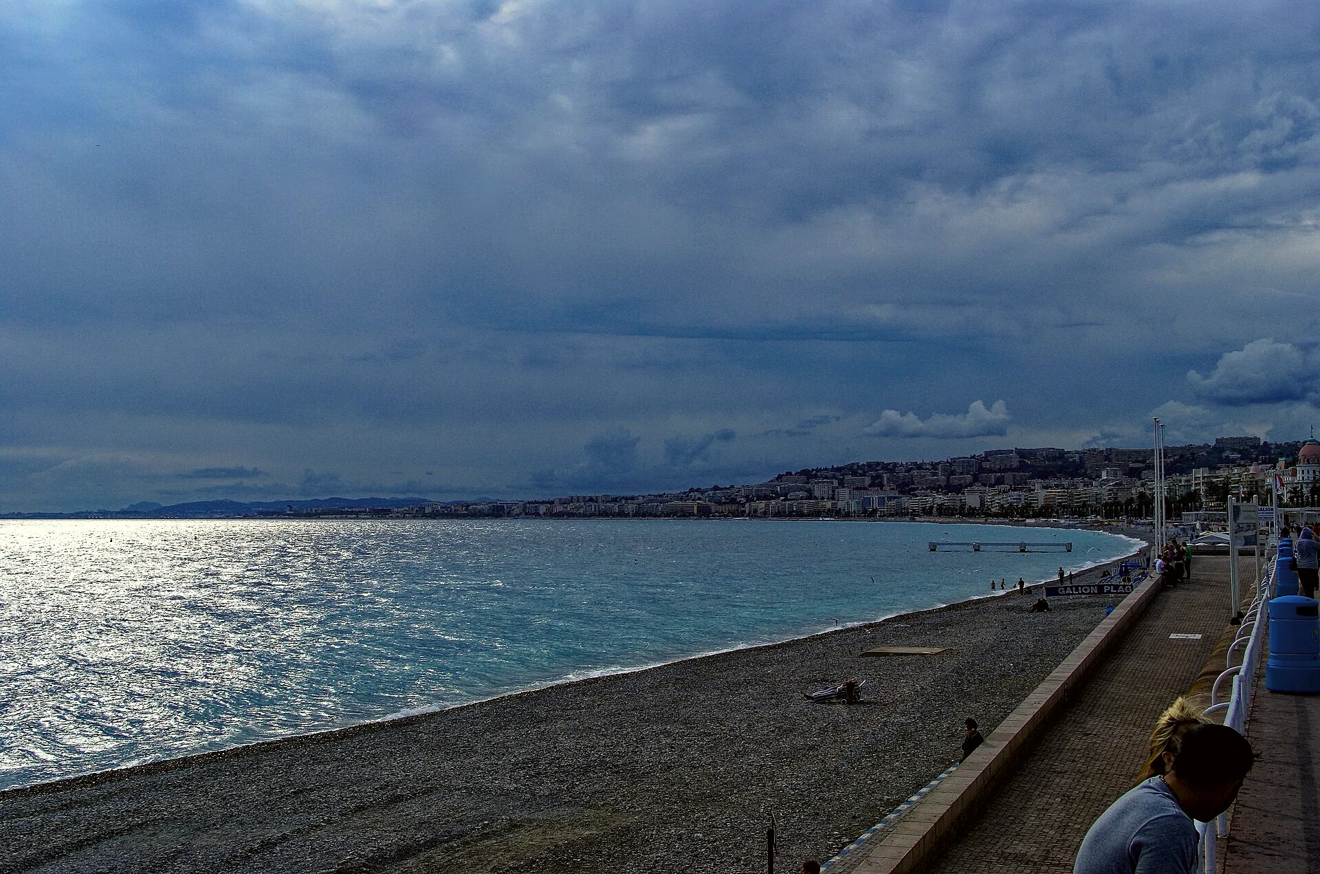 The Promenade des Anglais curves along the Nice waterfront beside the sea.