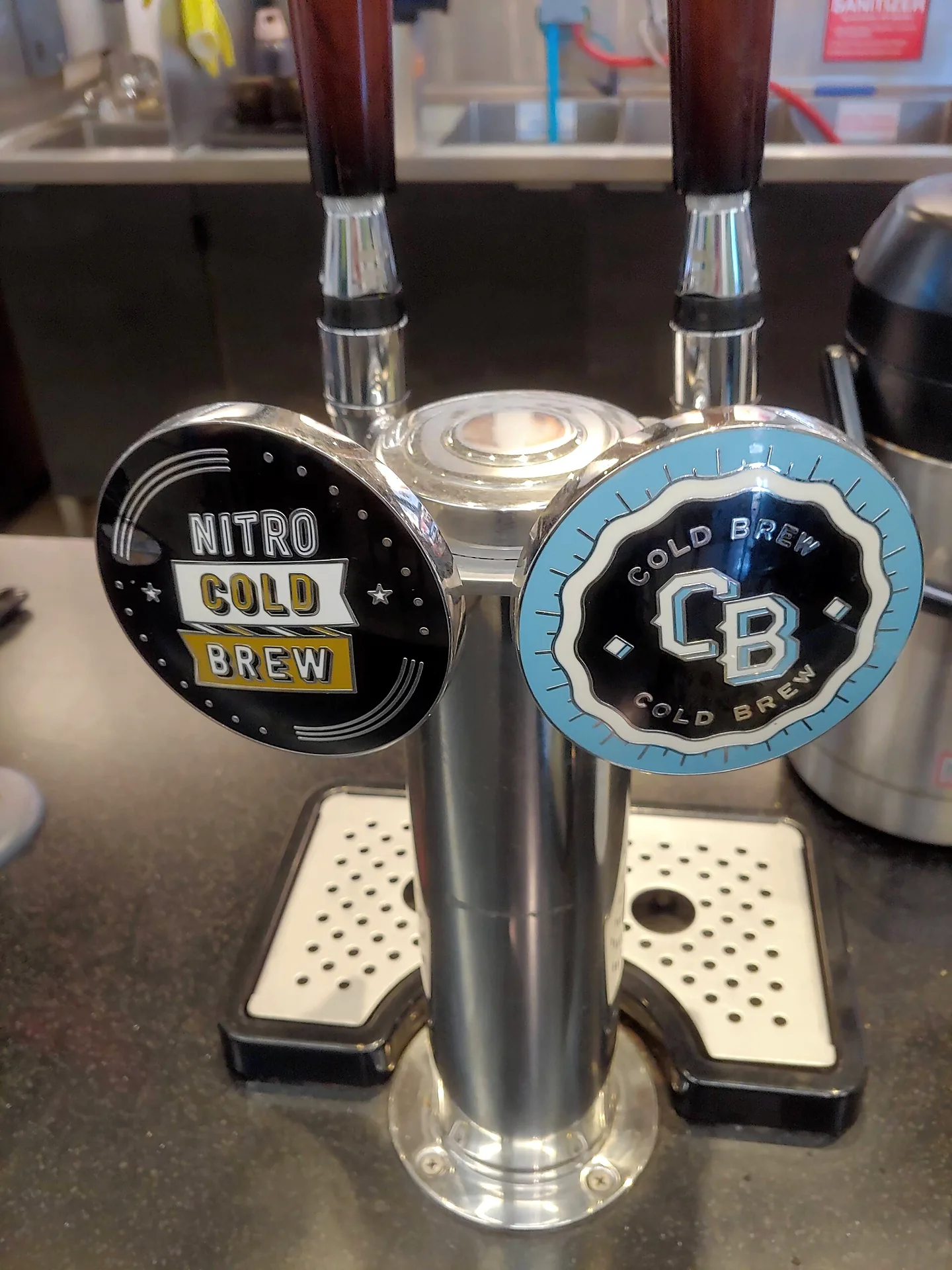 Two taps dispensing standard and nitro cold brew coffee.